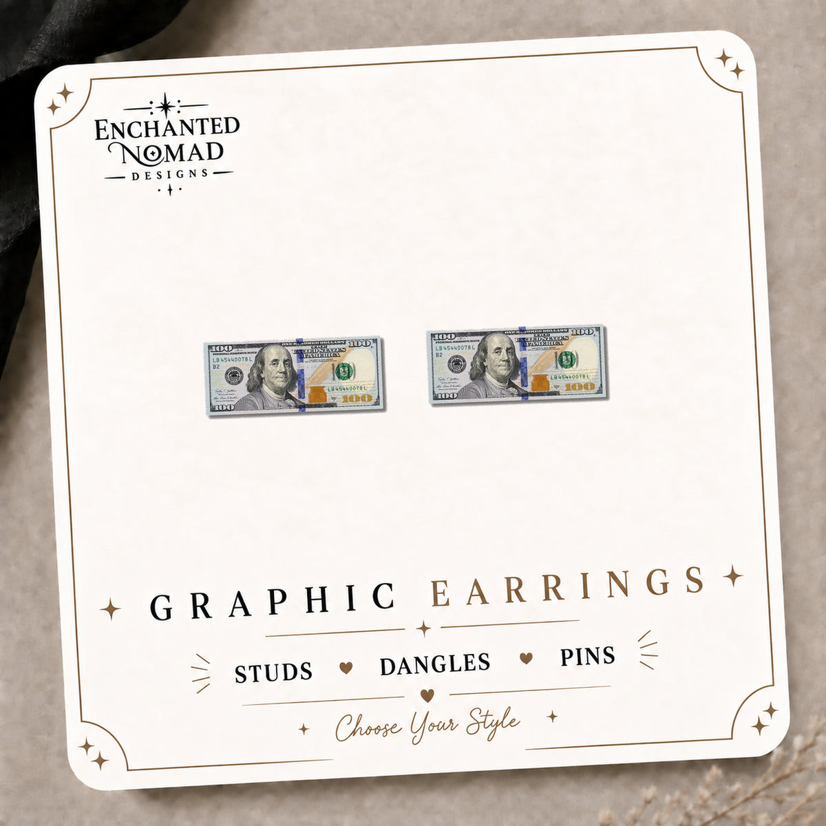 100 Dollar Bill Earrings & Pins on the tilted Enchanted Nomad Designs card
