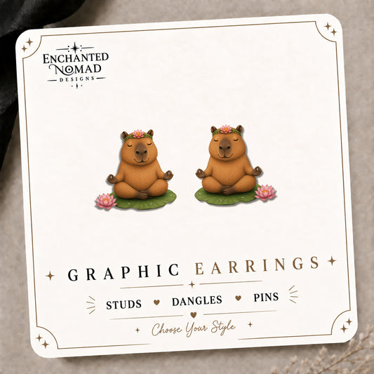 Capybara Meditation Stud Earrings on the tilted Enchanted Nomad Designs card