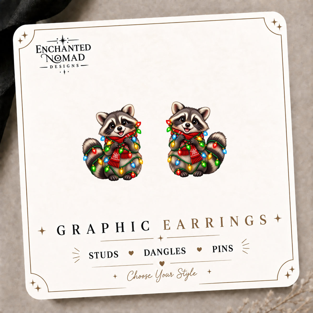 Christmas Lights Raccoon Stud Earrings on the tilted Enchanted Nomad Designs card