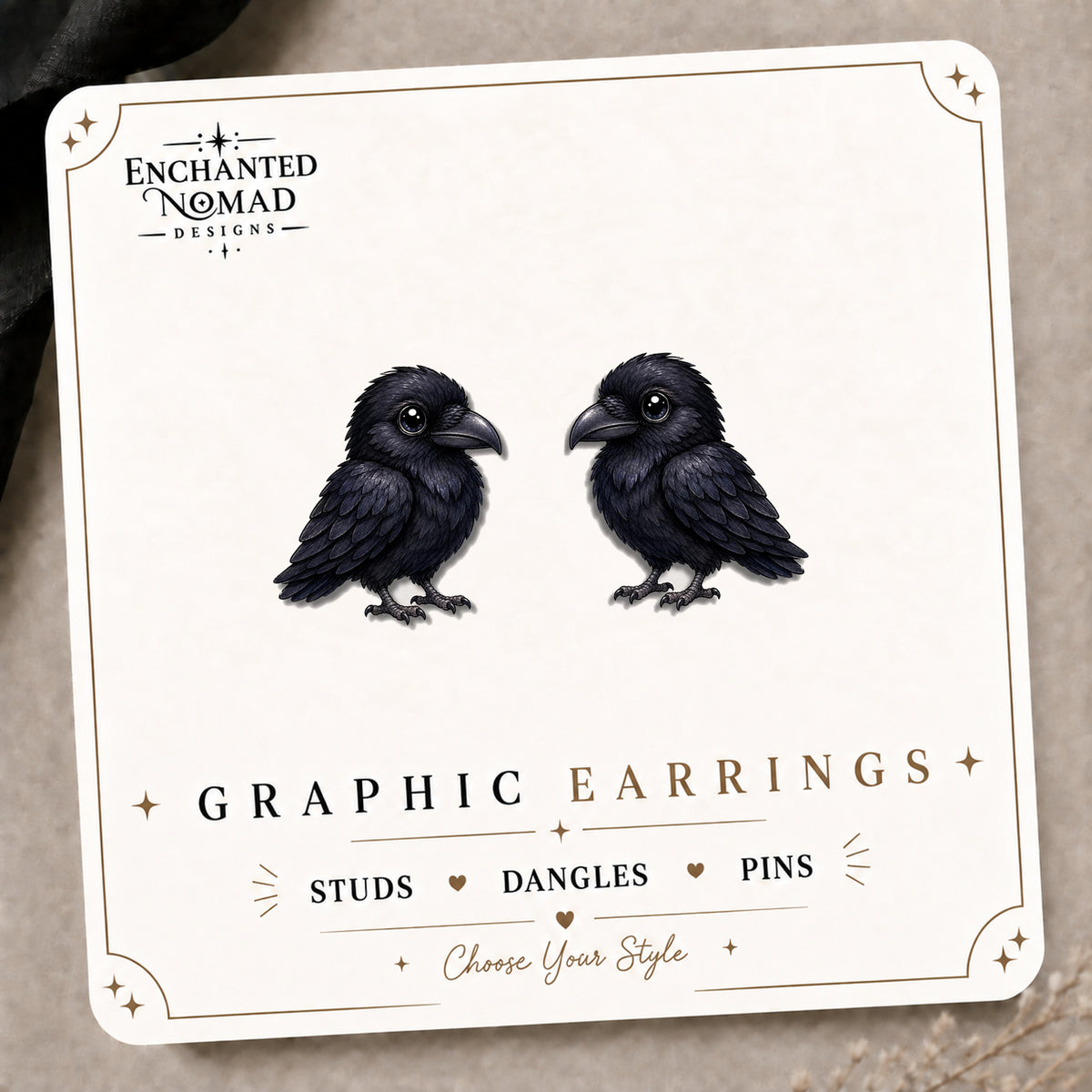 Cute Black Raven Stud Earrings on the tilted Enchanted Nomad Designs card