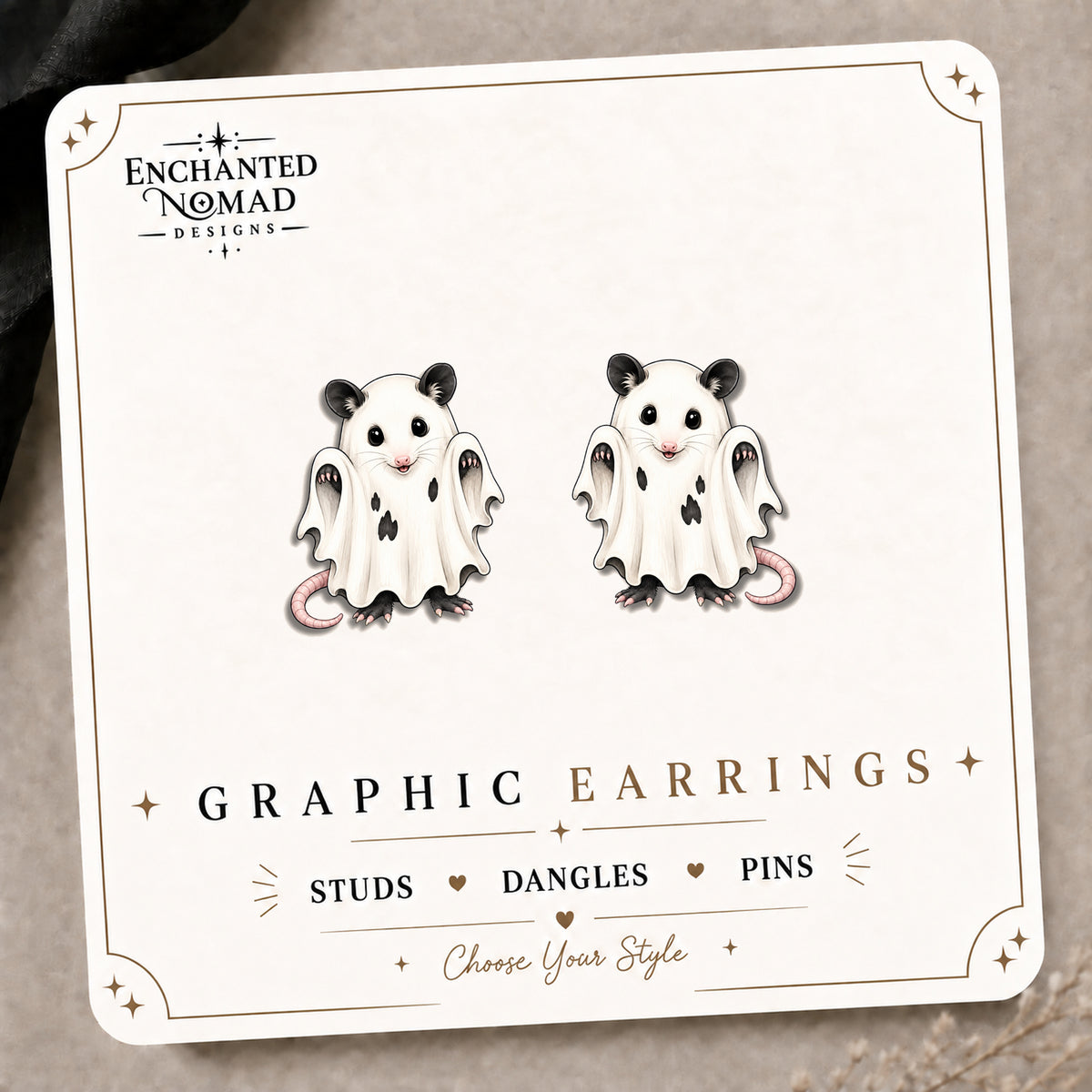 Ghost Opossum Stud Earrings on the tilted Enchanted Nomad Designs card