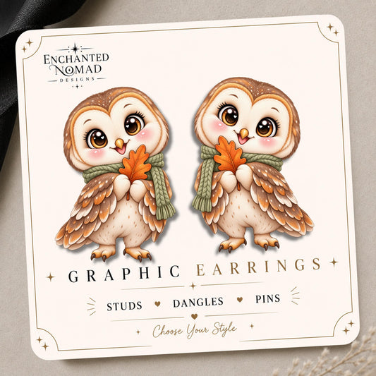 Autumn owl with a sage green scarf and orange leaf on the tilted Enchanted Nomad Designs display card