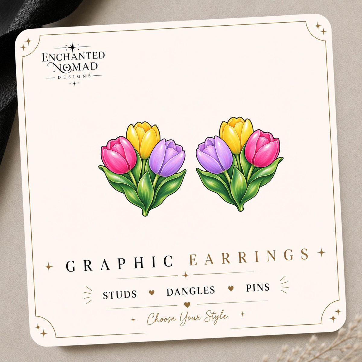 Tulip graphic earrings and pins on a display card