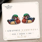 Wood Duck graphic earrings and pins on a display card