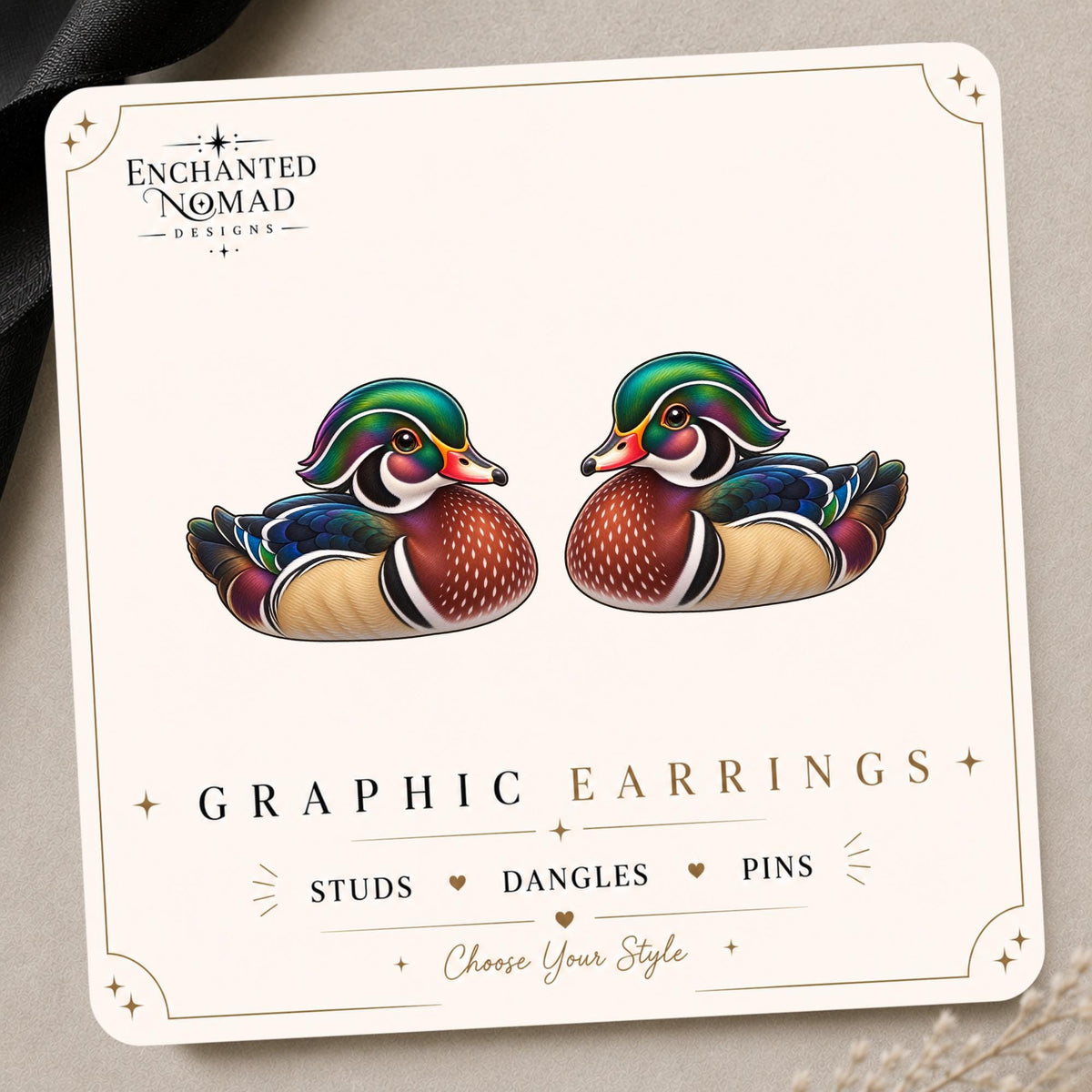Wood Duck graphic earrings and pins on a display card