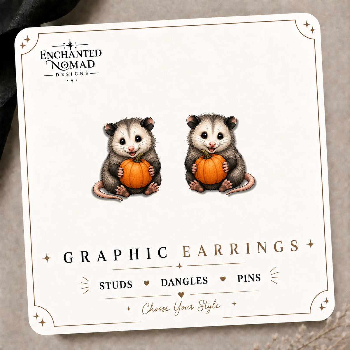 Opossum Pumpkin Stud Earrings on the tilted Enchanted Nomad Designs card