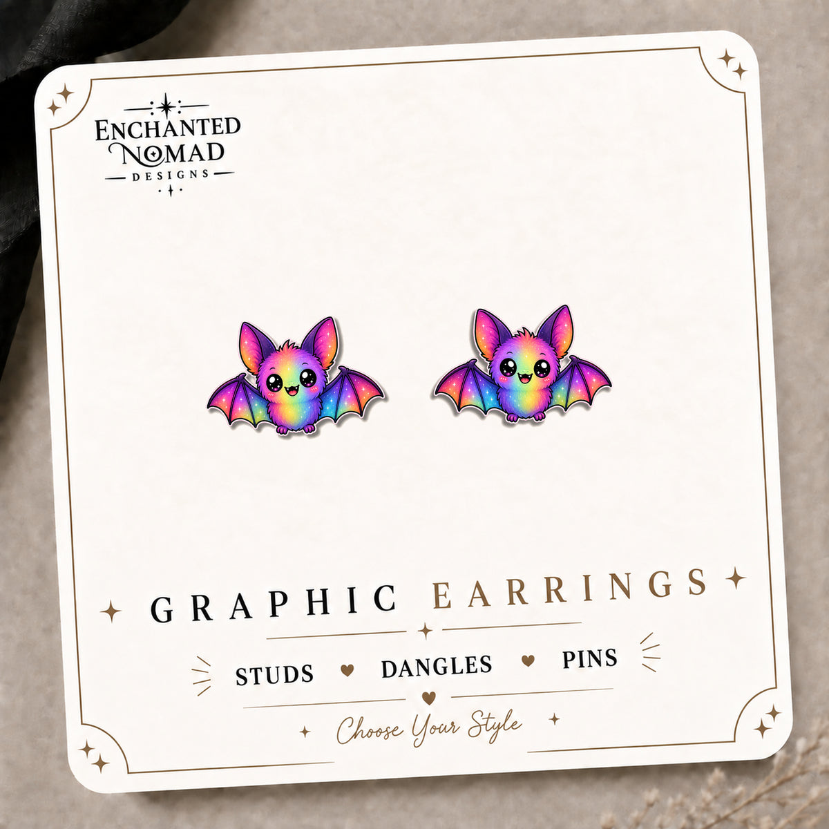 Rainbow Bat Earrings & Pins on the tilted Enchanted Nomad Designs card