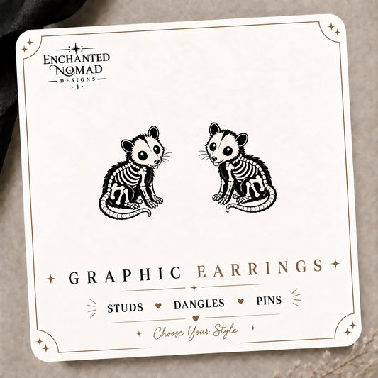 Sitting Skeleton Opossum Stud Earrings on the tilted Enchanted Nomad Designs card