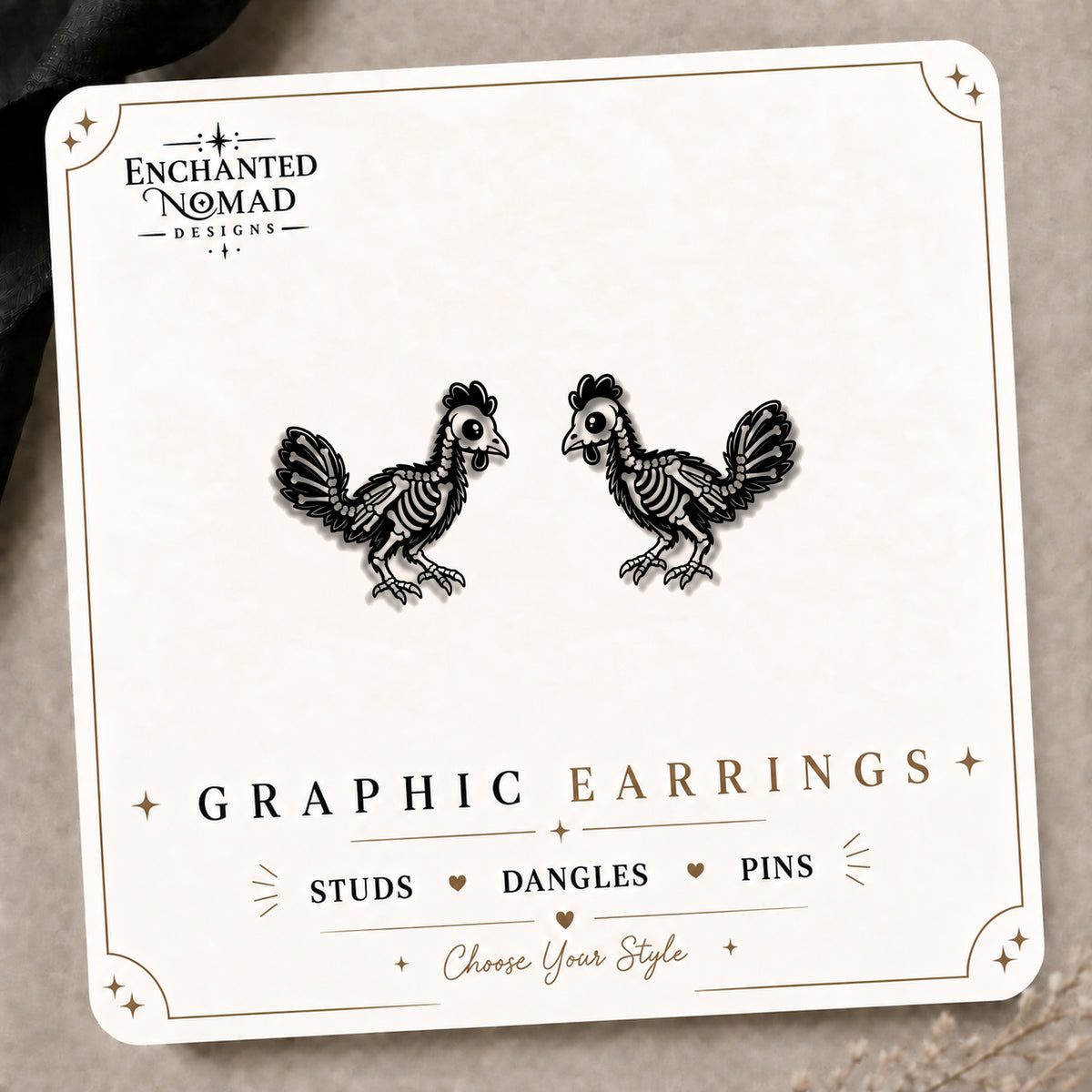 Skeleton Chicken Stud Earrings on the tilted Enchanted Nomad Designs card