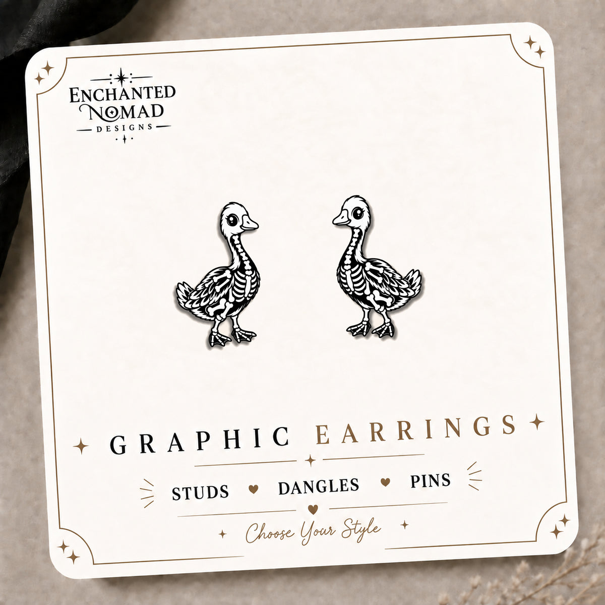 Skeleton Goose Stud Earrings on the tilted Enchanted Nomad Designs card