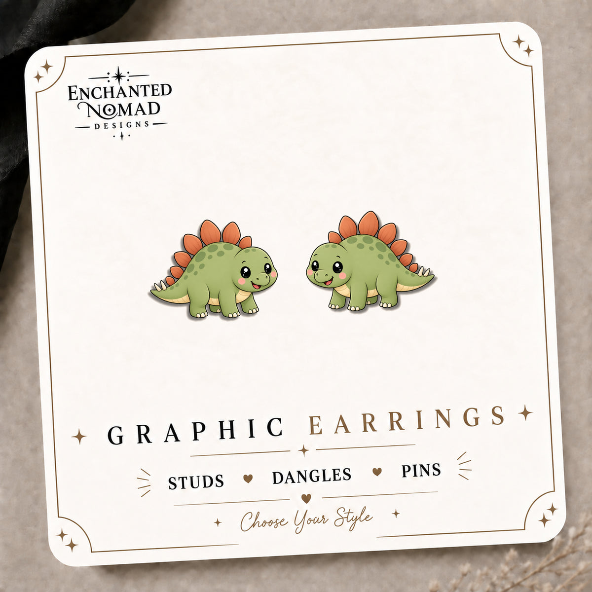 Stegosaurus Stud Earrings on the tilted Enchanted Nomad Designs card