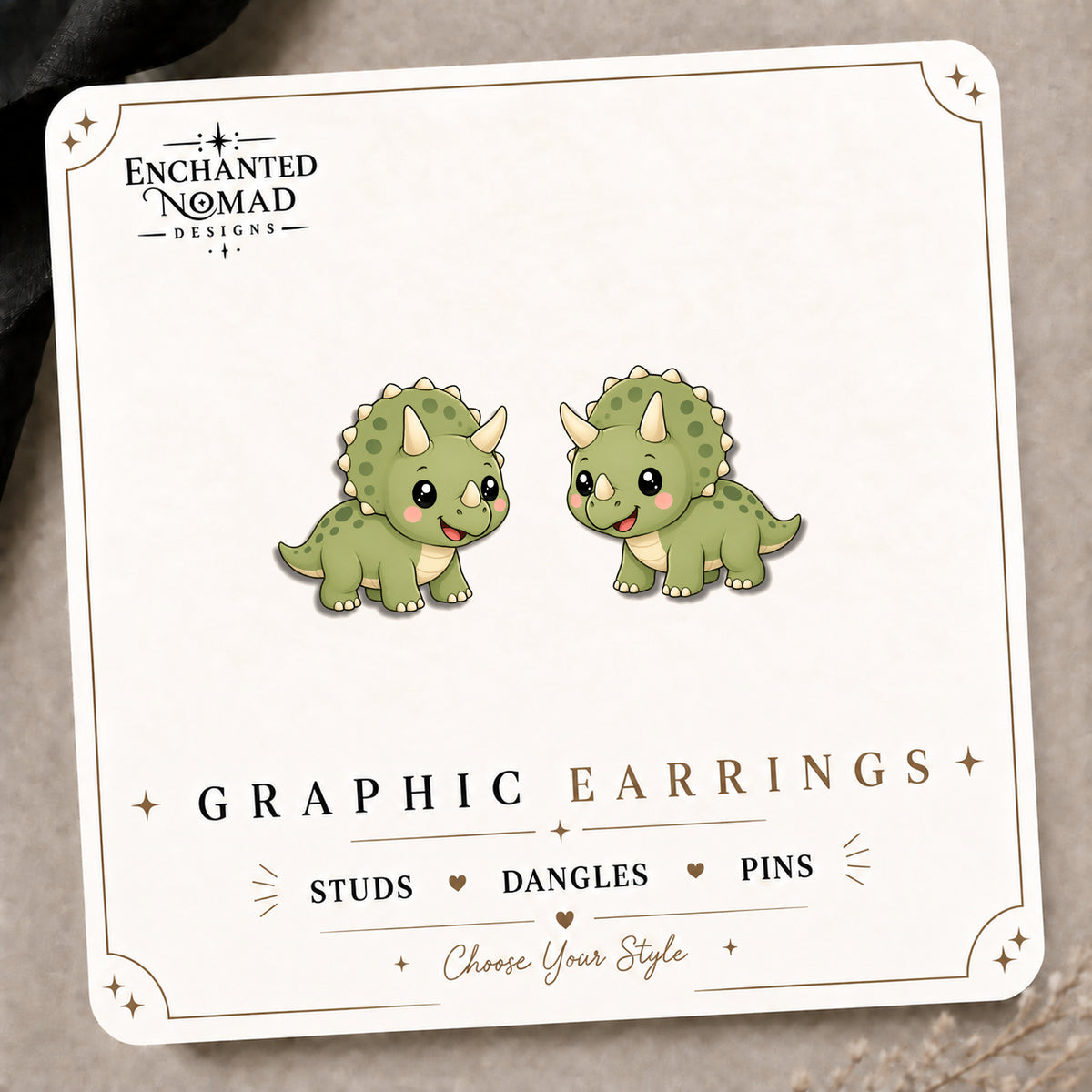 Triceratops Stud Earrings on the tilted Enchanted Nomad Designs card