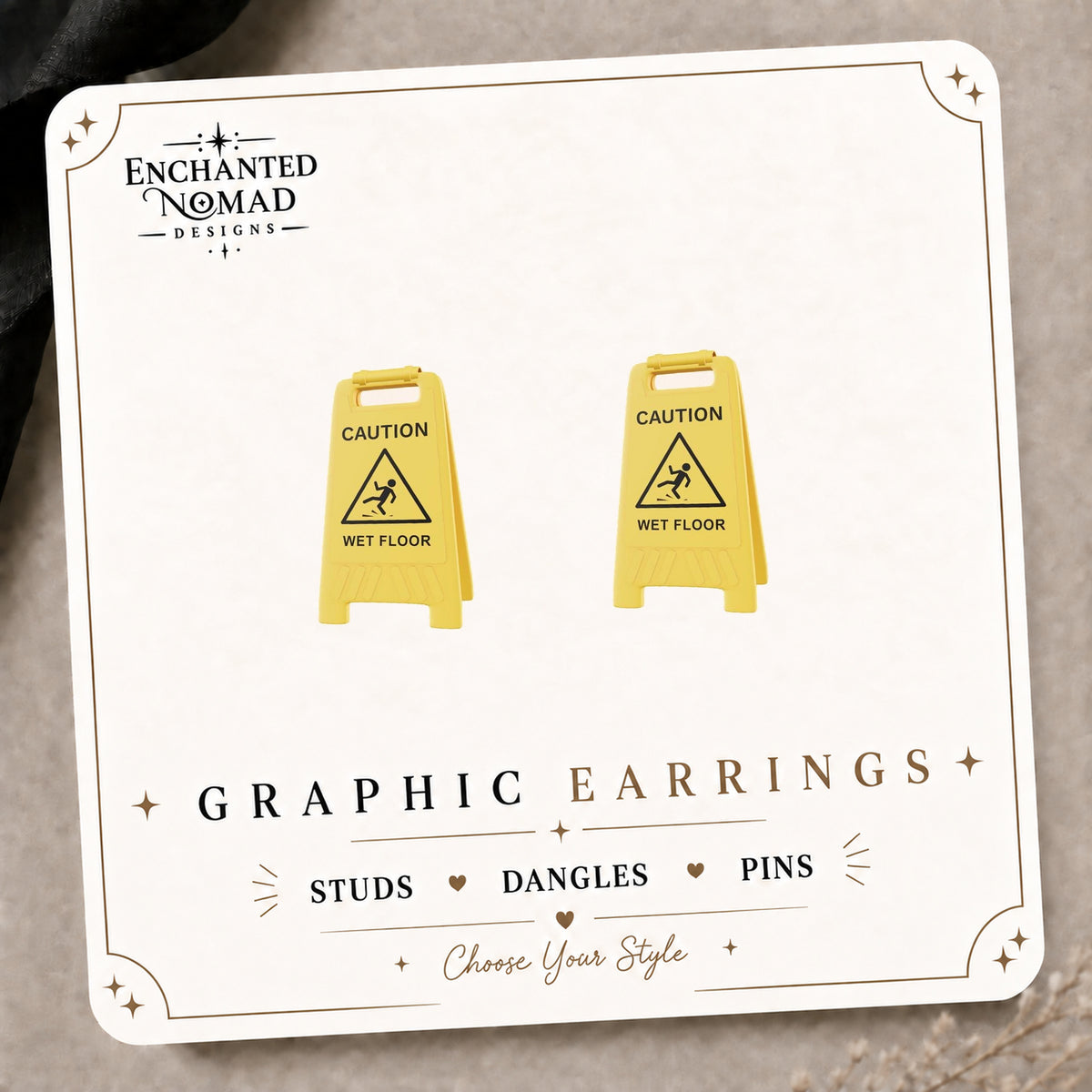 Wet Floor Caution Sign Stud Earrings on the tilted Enchanted Nomad Designs card